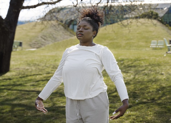 woman stretching outdoors medium shot